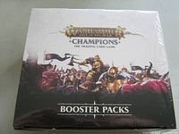 Front view of sealed booster pack box showing Warhammer Age of Sigmar Champions artwork and branding.