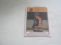 Front of 1980/81 Wayne Gretzky OPC #392 hockey card titled 'Record Breaker,' showing Gretzky in Oilers uniform.