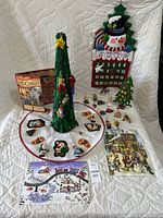 Full view of the lot showing handmade felt advent calendar, felt tree with skirt, multiple felt ornaments, wooden advent calendar, and two paper advent calendars arranged on a white backdrop.