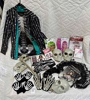 Full lot laid out showing skeleton suit jacket, skeleton shirt, wigs, masks, gloves, accessories, and packaging.