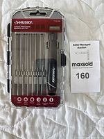 Packaged Husky 7-piece precision needle file set showing six different file shapes plus handle.