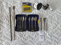 Full view of two Irwin plastic cases holding various sizes of spade drill bits and two long drill bits, plus Lenox hole saws and Irwin pilot drill bit set