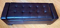 Top view showing the quilted upholstered leather surface with tufted square pattern and cushioned seat.