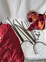 Disassembled brown metal 3-blanket holder stand with screws and two blankets partially visible.