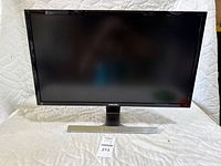 Front view of Samsung monitor showing screen, bezel, stand and brand logo.