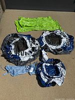 Set of 5 inflatable items including 2 blue/gray/white tubes, 1 cooler, 2 green air rafts, and mesh carry bag