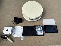 Full lot arranged showing radar dome, user manual with CD, cables, mounting brackets, Simrad control display.