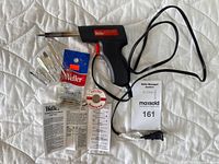Weller Therma-Boost TB-400 soldering iron with power cord, assorted metal bits and spatulas, and Weller branded packaging for bits.