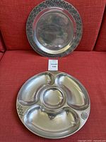 One Wilton Armetale divided serving tray showing Reggae pattern engraved designs and three large compartments plus a round central space for serving or meal prep.