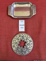 Rectangular serving tray and round trivet side by side showing the full set.