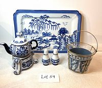 Front view of the complete lot showing teapot with warmer, rectangular platter, salt and pepper shakers, and Wedgwood ice bucket with caddy.