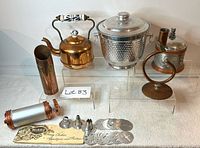 Lot showing six vintage copper and aluminum home decor items arranged on white background.
