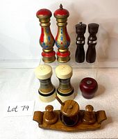 Five sets of vintage and MCM salt and pepper shakers shown on white cloth, detailed front view