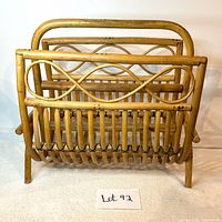 Front view of vintage bamboo magazine stand showing woven slats and decorative bamboo pattern
