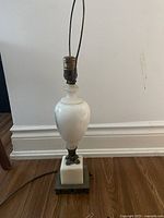 Full view of the vintage marble and brass lamp without shade, showing the marble body and brass base.