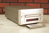 Front left angle shot of Esoteric P-500 CD transport and remote control showing unit's front panel and tray.