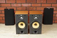 Two speakers side by side with removable grills placed behind