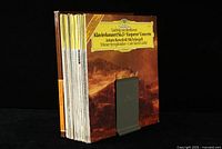 Stack of approximately 24 classical music vinyl LP records, all German pressings from DGG label, standing vertically with Antonio Benedetti Michelangeli Beethoven album front visible