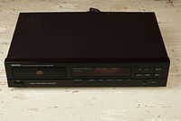 Front view of Denon DCD 460 CD Player showing the full face including control buttons and display under lighting.
