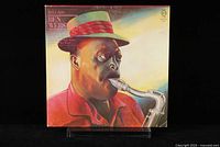 Front cover of Ben Webster Ballads vinyl record LP showing illustrated portrait of Ben Webster playing saxophone in vibrant colors.