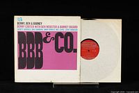 Front cover and partially visible red Prestige record inside white inner sleeve.