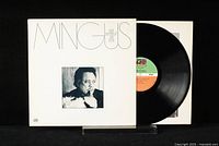 Front view of Charles Mingus vinyl record album cover partially open showing the vinyl disc and sleeve inside.
