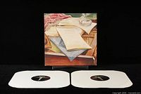 Front cover of the Charlie Parker Norman Granz Jam Session LP showing two vinyl records laid out next to it.