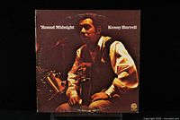 Front cover of Kenny Burrell 'Round Midnight vinyl LP showing artist and title with photo of Kenny Burrell.