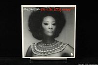 Front cover of the Marlena Shaw album "Who Is This Bitch, Anyway?" showing the artist's black and white portrait with prominent necklace and red title text.