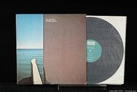 Photo showing Pat Metheny Watercolors vinyl LP partially removed from its gatefold cover and white inner sleeve, displaying the ECM label on the vinyl record.