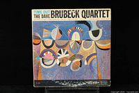 Front cover of The Dave Brubeck Quartet Time Out LP showing colorful abstract artwork and album title.