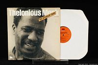 One of the vinyl LPs from Thelonious Monk The Riverside Trios, partially pulled out of protective white sleeve showing orange Milestone label