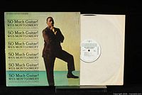 Front of the vinyl record sleeve with the album cover art showing Wes Montgomery standing with one foot raised, green background and repetitive text title.