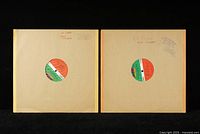 Two vinyl LP records in plain tan paper sleeves with Atlantic label visible. Both sleeves have handwritten notes 'No Cover John Coltrane'.