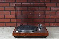 Full front view of turntable with dust cover closed showing overall appearance and condition