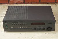 Front angled view of NAD C 740 showing top ventilation and front panel buttons and knobs.