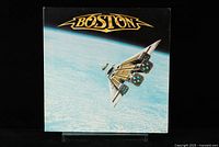 Front cover of Boston Third Stage vinyl LP showing spaceship guitar artwork against blue space background.