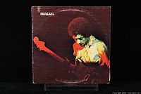 Front album cover shows Jimi Hendrix playing guitar with dark and warm tones, no significant damage visible.