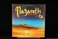Front cover of Nazareth Greatest Hits vinyl LP showing sunset background and band title.