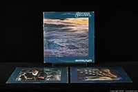 Two vinyl LP records displayed with inner sleeves showing photographic images related to Santana, placed below album cover.
