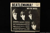 Front cover of The Beatles 'Beatlemania!' vinyl LP record showing black and white portrait of the band members and album title.