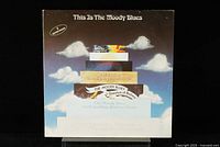 Front cover of the boxed 2 LP set titled 'This Is The Moody Blues' showing a stacked design, clouds background and Threshold label.