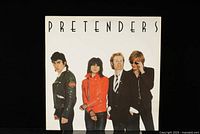 Front cover of The Pretenders vinyl record LP showing a white background with the four band members.