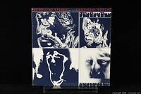 Front cover of The Rolling Stones Emotional Rescue LP showing abstract artwork in black and white quadrants.