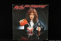 Front cover of the Metal For Breakfast vinyl LP showing person with long hair pouring red liquid into a bowl