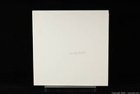 Front cover of The Beatles The White Album showing plain white cover with faint text