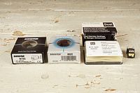 Four cartridge boxes and one loose cartridge on wooden surface