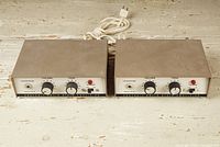 Pair of Heathkit monoblock integrated amplifiers side by side showing top and front with power cords coiled behind