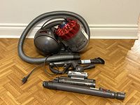 Main vacuum body with attached hose and visible accessories laid out