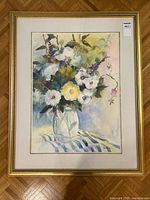 Full view of the framed watercolor painting showing floral still life with glass vase and striped cloth.